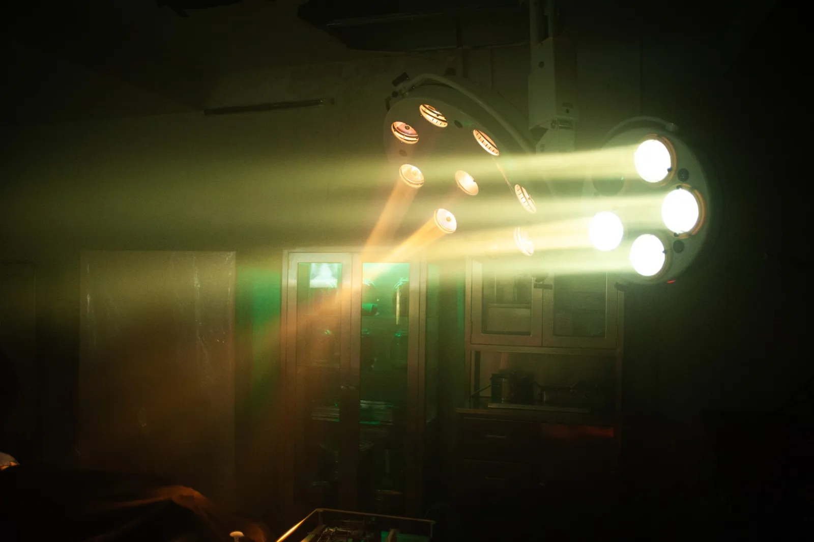 Holy Smear set: an operating lamp cutting through haze in the ward