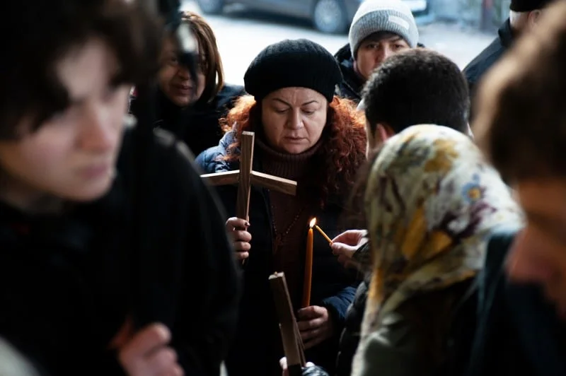 Holy Smear still: a procession with a cross and candles