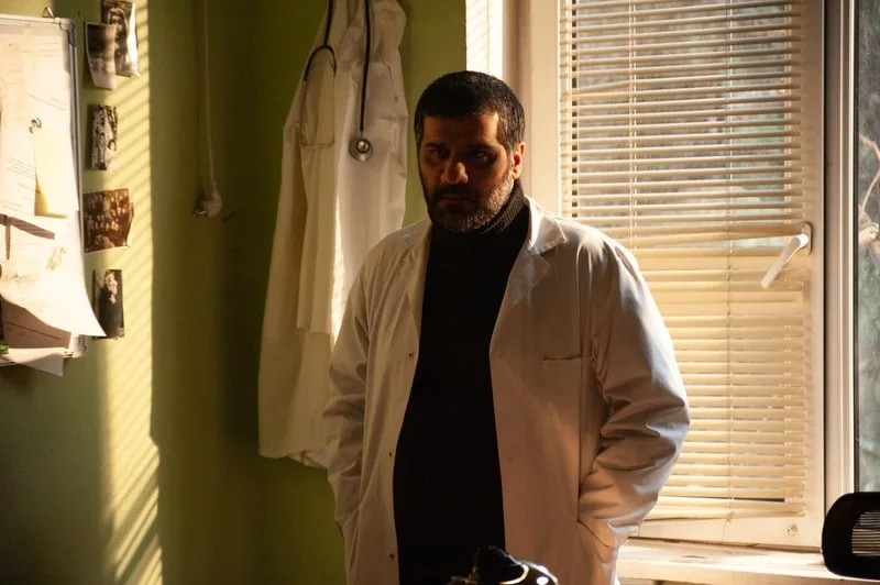 Holy Smear still: a doctor in a white coat by the window