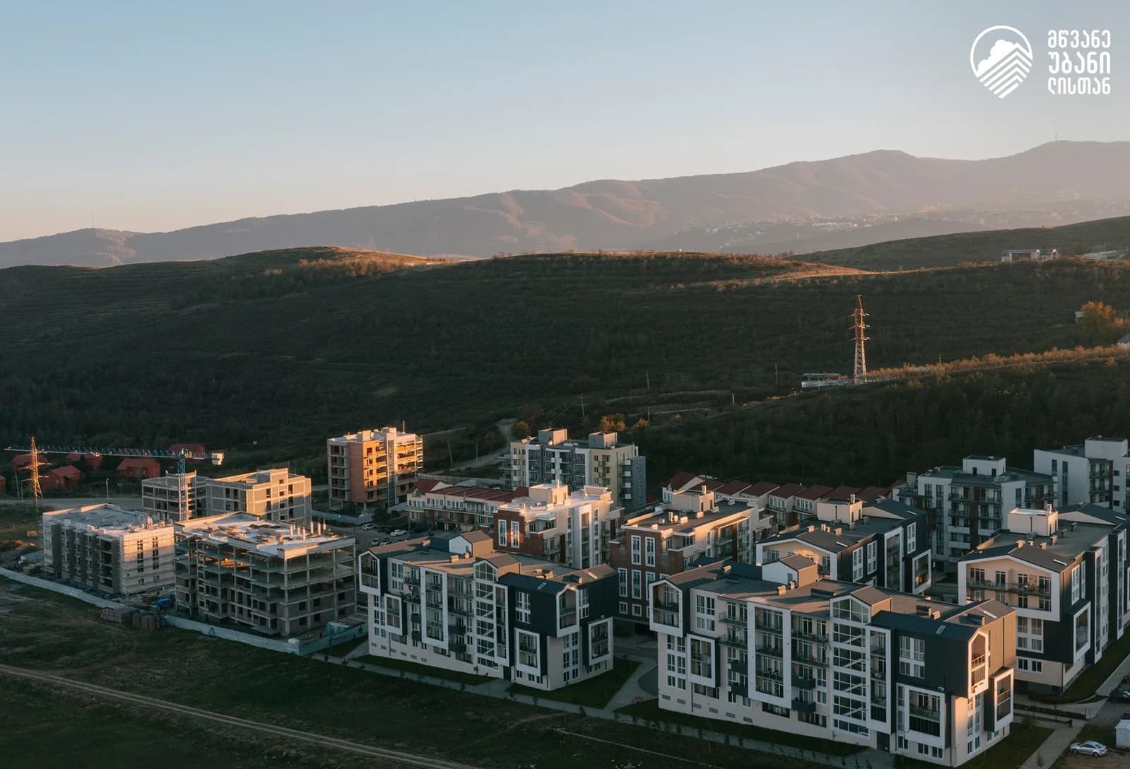 Real estate ad: aerial view of a residential district at sunset